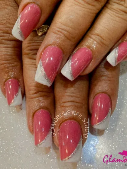 A modern take on a classic color. This design features a glossy pink polish with a diagonal white tip and a clean line of silver glitter for a sharp, stylish finish.