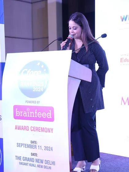 Focused on my script and cues during the Cfore School Rankings award ceremony.