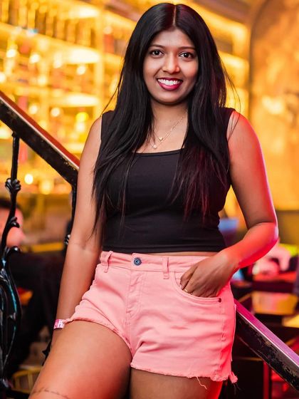 A guest in pink shorts, looking ready for a fun night.