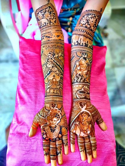 A multi-layered story mehendi with portraits. The design shows the couple on the palms, with other figures and traditional elephant motifs on the arms.