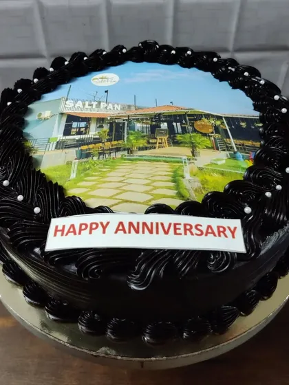 A custom photo anniversary cake featuring a picture of the Salt Pan restaurant. A great way to commemorate a special place.