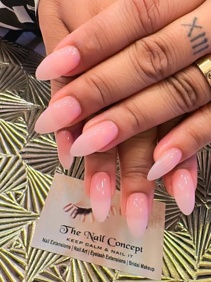 A beautiful and natural-looking pink ombre on long, almond-shaped nails. The subtle gradient gives a healthy and polished appearance.