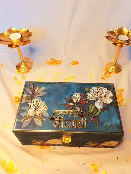 This hand-painted wooden box is a gift in itself. For Diwali, I fill this beautiful blue floral box with goodies, making it a reusable keepsake that your loved ones will cherish long after the festival.