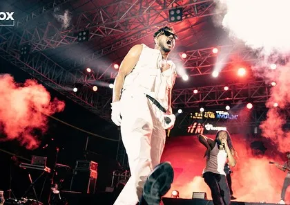 Another high-energy shot of King on stage, with red-tinted smoke adding to the dramatic effect.