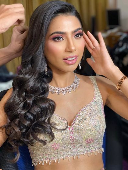 A candid moment during the getting-ready process. You can see the soft, blended eyeshadow and the glowing skin that make this look so magical.