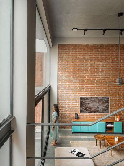 From the upper level, you can appreciate the scale of the double-height living space and its connection to the garden. The open staircase maintains a sense of lightness, ensuring views are unobstructed throughout the home.