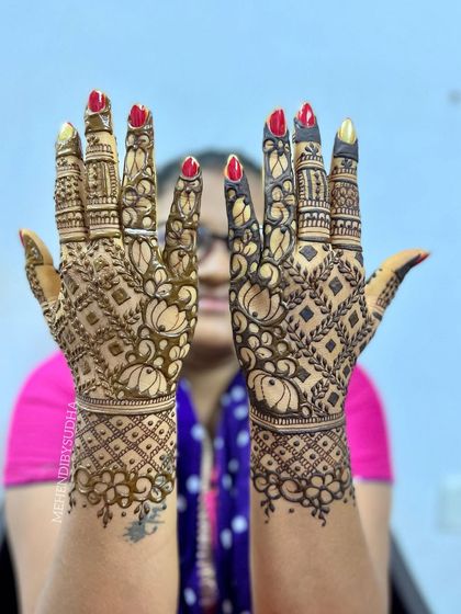 A full back-hand design with a dense lotus and check pattern, perfect for a close relative of the bride or groom.