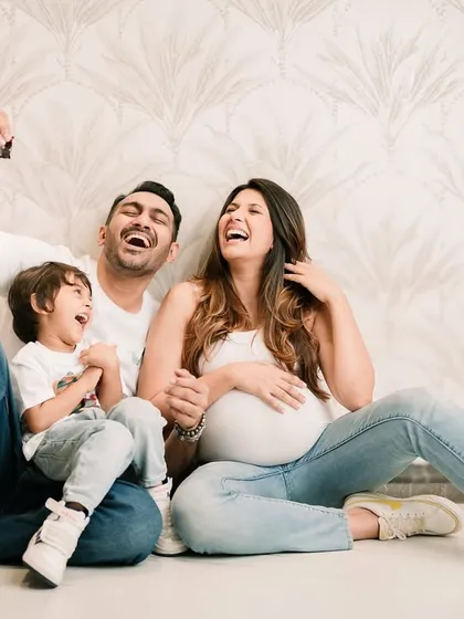 Pure joy and laughter while waiting for the new arrival. This maternity session captures the fun and excitement of a growing family.