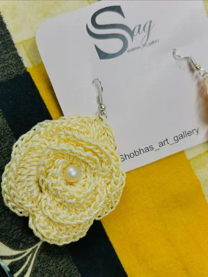 Another angle of the cotton thread rose earring, showing the delicate hook and craftsmanship. They are designed to be very light on the ears.