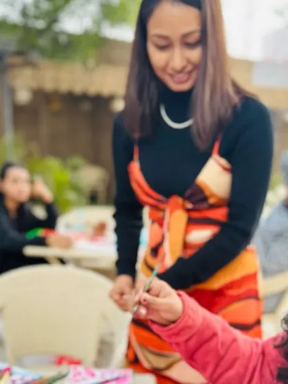 A close-up of me guiding a participant during a painting session. I'm here to help with techniques, color mixing, or just to give a little encouragement. No experience is needed, just an open mind.