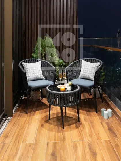 This wide shot shows how even a small balcony can be transformed into a stylish and functional outdoor space with the right furniture and a few thoughtful details.