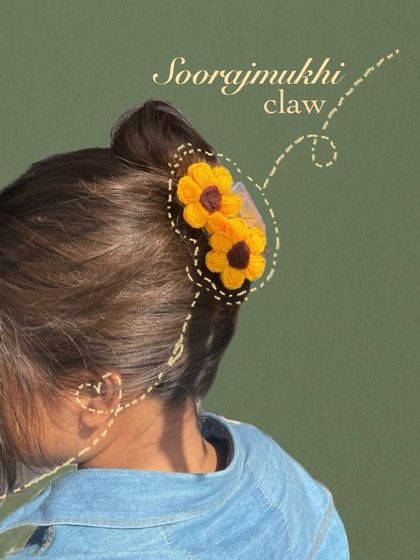 My "Soorajmukhi" (sunflower) claw clip, as seen in action. This annotated photo shows how the crochet flowers are attached to the clip, creating a unique and eye-catching hair accessory.