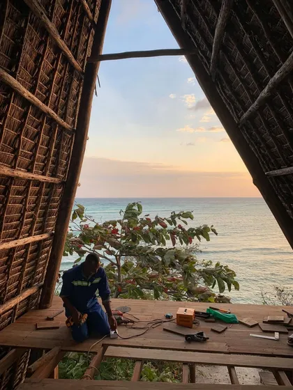In Zanzibar, we designed this spa to be an open-air sanctuary with an uninterrupted view of the ocean. A local craftsman puts the finishing touches on the deck as the sun sets, capturing the hands-on, collaborative spirit that brings our tropical architecture projects to life.