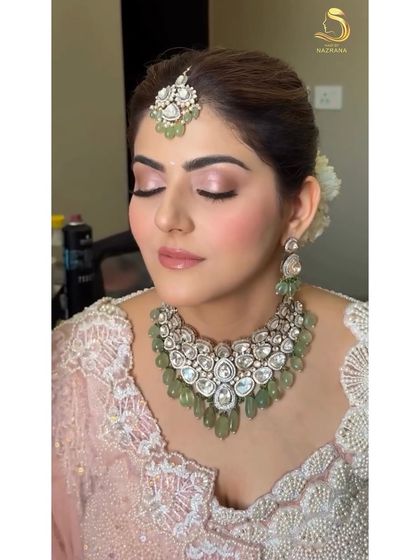 A beautiful portrait of the bride, with her soft makeup and the elegant textured bun just visible.