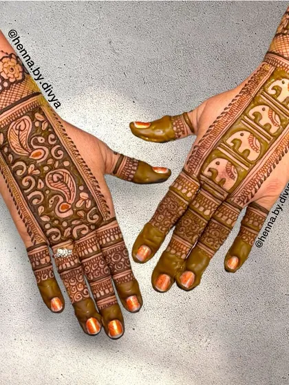 This back-hand design features a band of elephants and paisleys. It's a unique layout that leaves some skin showing while still feeling traditional and ornate.