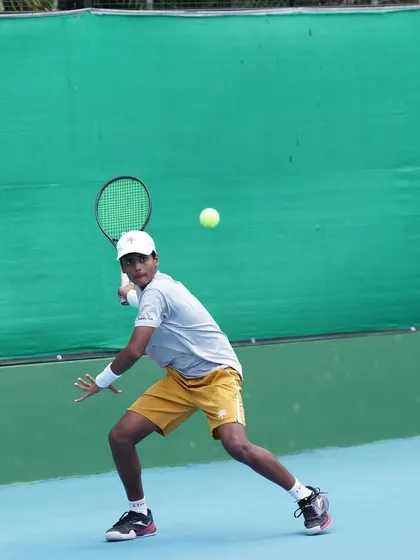 Generating power from the ground up. This photo captures the dynamic balance and core rotation we teach for powerful groundstrokes during a match-play scenario.