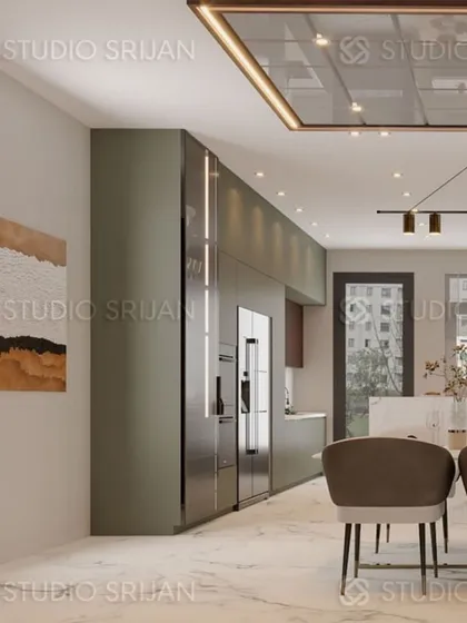 In this Model Town home, the dining area is integrated with the kitchen, marked by a dropped ceiling with lacquered glass and focused lighting. The design ensures a smooth transition between the cooking and dining zones.