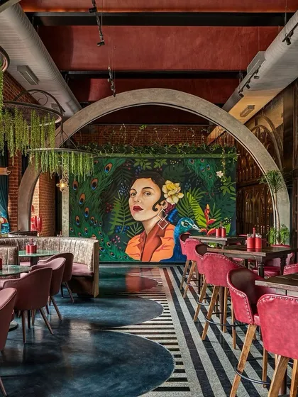 We love creating a mood. This painterly mural of a woman with a peacock became the stunning centerpiece for this restaurant's interior. It demonstrates our skill in creating sophisticated, atmospheric art that elevates the entire dining experience.