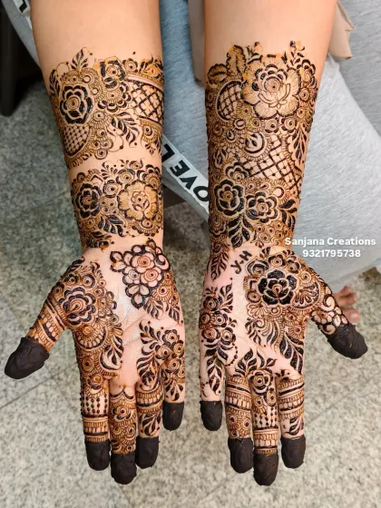 The final look of this gorgeous floral mehndi, with filled fingertips that complete the traditional yet modern aesthetic.
