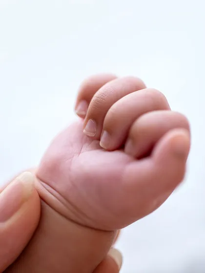 A tightly clenched fist, full of newborn strength. This macro shot freezes a tiny but powerful detail in time.