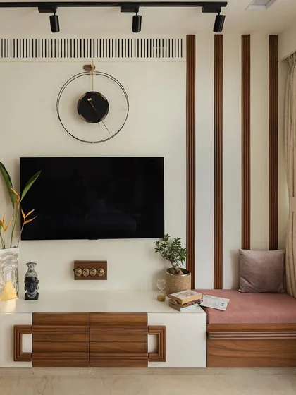 The master bedroom's TV unit extends into a cozy seating nook by the window, perfect for reading or contemplation.