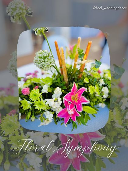 A "Floral Symphony" centerpiece with a mix of colorful flowers, adding a vibrant and fresh touch to the dining tables.