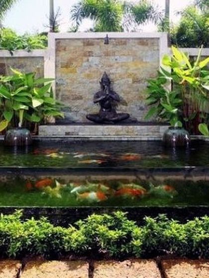 We bring tranquility to your doorstep with custom aquatic features. This serene pond, complete with a calming Buddha statue and thriving plants, is designed to be a focal point of peace and natural beauty in your garden.