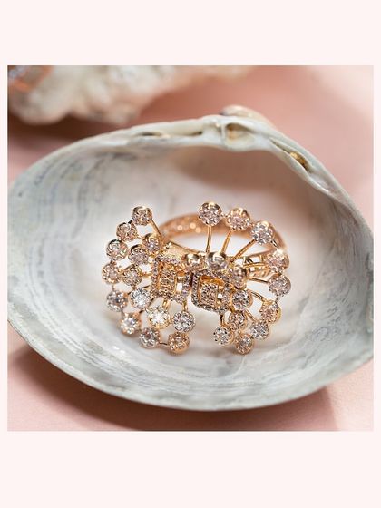 A brilliant, starburst-style diamond ring, crafted with dozens of small diamonds to create maximum sparkle.