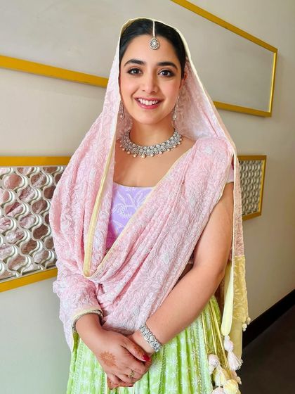 Rosy cheeks, clean makeup, and pretty pastels for this sister of the bride on a winter wedding morning. Her warm smile is the perfect finishing touch.