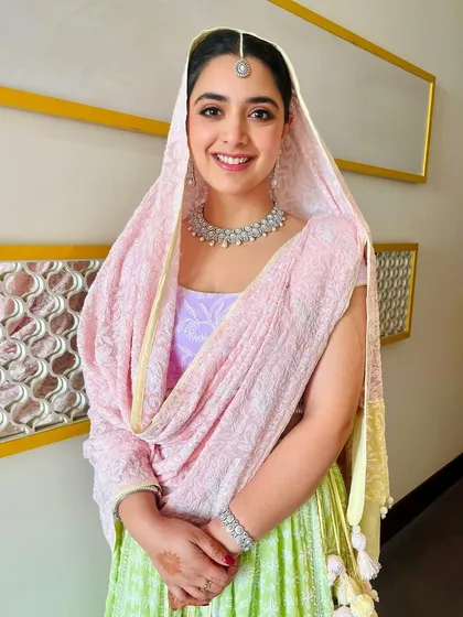 Rosy cheeks, clean makeup, and pretty pastels for this sister of the bride on a winter wedding morning. Her warm smile is the perfect finishing touch.