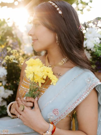 A beautiful profile shot of the bride in the sunlight. Her skin looks luminous, and the makeup is subtle enough to let her natural beauty shine.