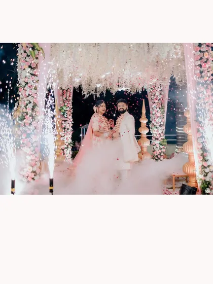 A magical varmala exchange with cold pyro sparklers creating a fountain of light. I coordinate these special effects to add a touch of glamour and excitement to your most important moments.
