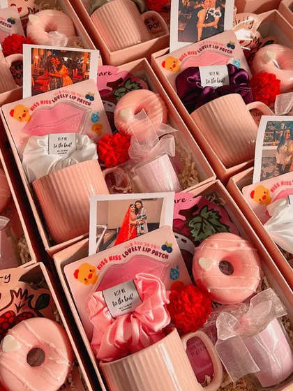 A sea of pink! These are some of my budget-friendly bridesmaid hampers, filled with mugs, donut soaps, scrunchies, and personalized cards.