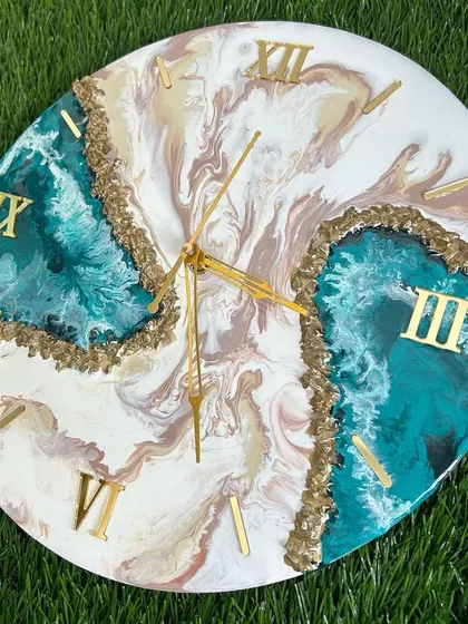 A beautiful combination of teal, beige, and white in this geode-style clock, accented with gold crystals.