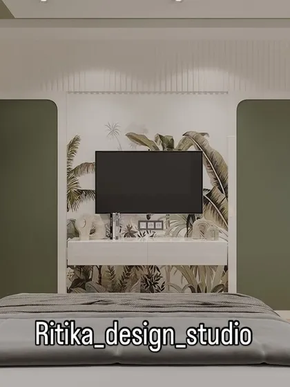This is a direct view of the entertainment wall in the green bedroom. The floating console and botanical wallpaper are framed by the rounded-edge wardrobe panels, creating a cohesive and thoughtfully designed feature wall that is both functional and decorative.