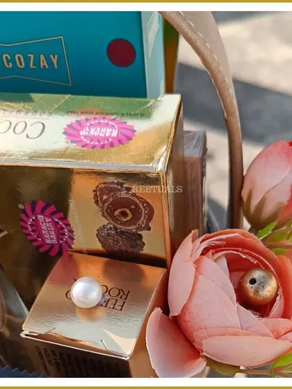A close-up of the premium chocolates and floral details that make this anniversary hamper a truly special gift.