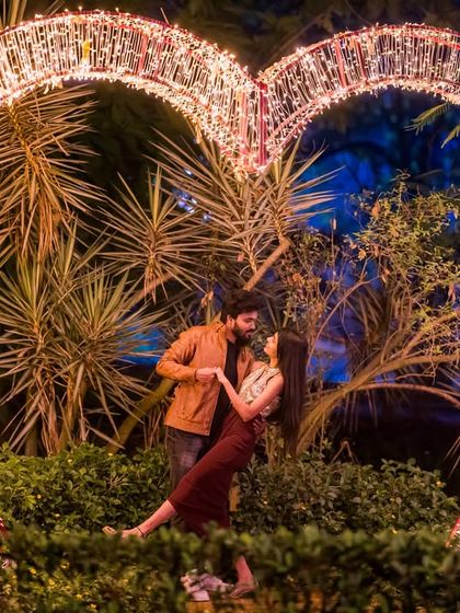 A playful and romantic dance in front of the heart-shaped light prop, capturing a moment of pure joy.