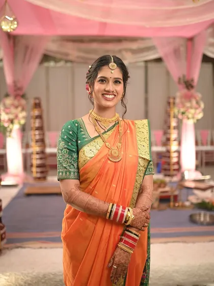 A smiling portrait of the bride, looking confident and happy. The subtle makeup enhances her features without overpowering her natural beauty.
