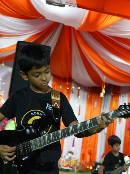 A young guitarist completely lost in the music. This picture captures the passion and focus we instill in our students.