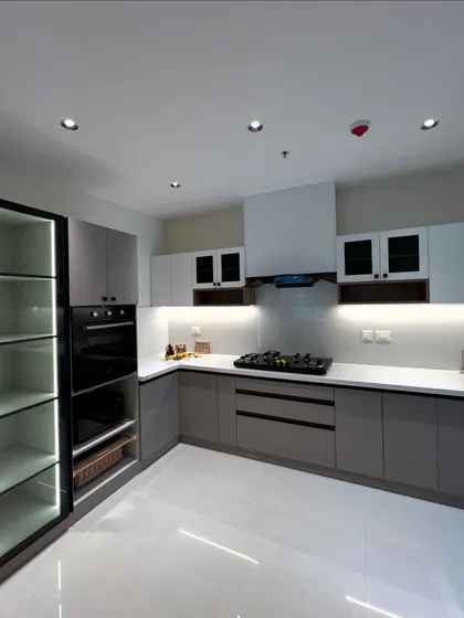 A kitchen should be a symphony of light and space. We designed this modern kitchen with a two-tone color scheme, integrated appliances, and layered lighting for a look that is sleek, functional, and timeless.