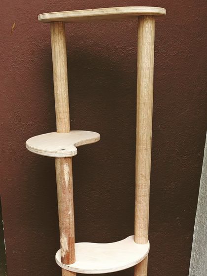 Another view of a cat tree in progress. This one is made from solid wood pillars and plywood platforms, designed to be both sturdy and stylish.