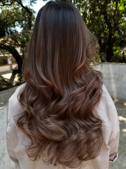 Another beautiful holiday hair transformation. We refreshed her color with a mix of beige and ash tones for a cool, sophisticated brunette look.