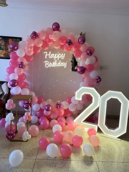 Perfect for a milestone birthday, this decoration combines our popular ring frame with large, illuminated marquee numbers. The pink and white balloon arrangement and "Happy Birthday" neon sign create a fun and personalized photo opportunity for the special day.