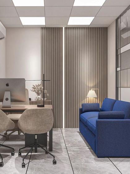 A private cabin within a larger office, featuring a comfortable blue sofa for quick breaks or informal chats. The wood-paneled walls add a touch of warmth.