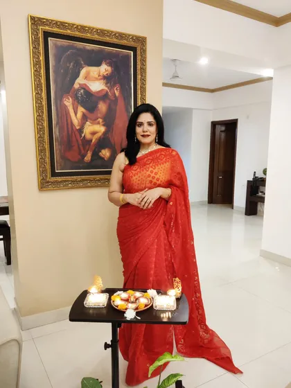 For Diwali, I decided to embrace the festive spirit with this vibrant red Jamdani saree. Paired with a traditional necklace, it was the perfect outfit for a quiet celebration at home. I love helping clients find the perfect look for festivals, whether it's grand or intimate.