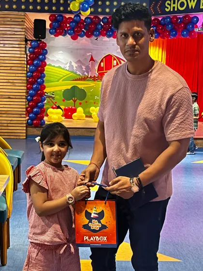 A guest receives a goody bag from our staff, a perfect end to a fun visit.