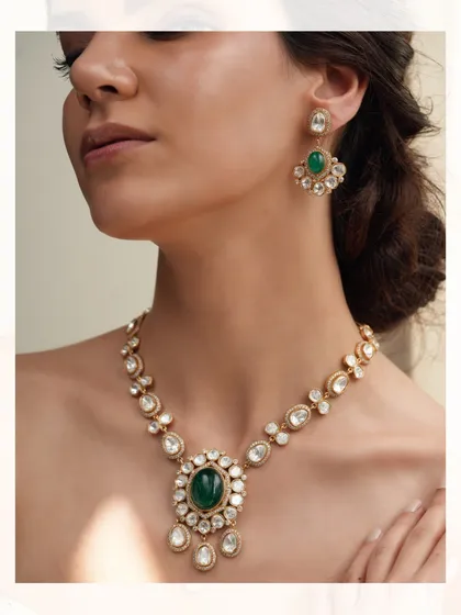 A beautiful polki necklace with a large emerald pendant, a timeless piece that exudes grace and sophistication.