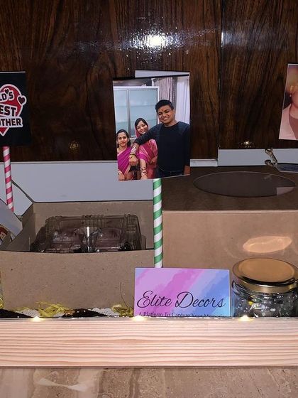 I can incorporate your personal photos to make the gift extra special. This Rakhi hamper for a brother includes multiple photo stands alongside jars of treats and other goodies in a personalized tray.