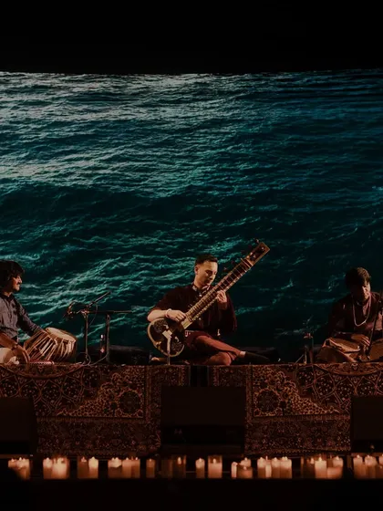 Playing the sitar with a backdrop of ocean waves. The sound of the sitar and the image of water create a powerful, flowing, and cleansing experience for the mind.