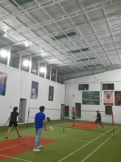 The court is alive with energy! A full view of a doubles match with players covering all corners.